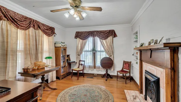 a living room with furniture a fireplace and a chandelier