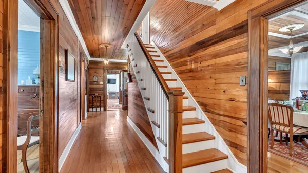 a view of an entryway with wooden floor and stairs