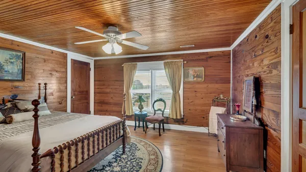 a bedroom with furniture and a large window