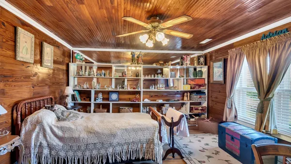 a bedroom with furniture and a chandelier