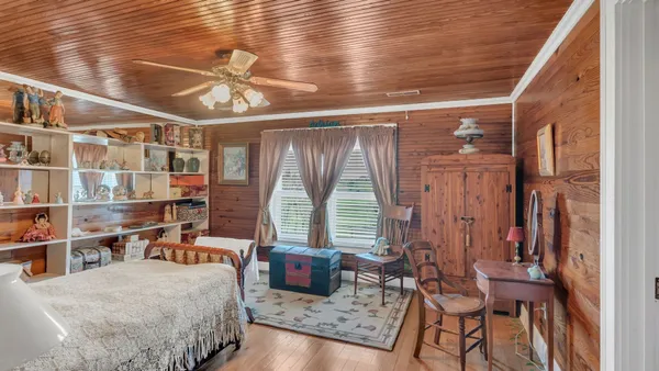 a bedroom with furniture and a window