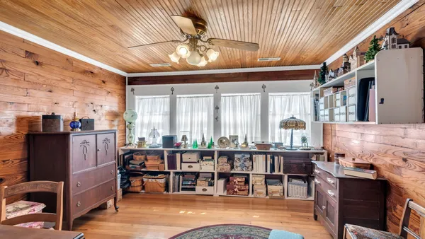 a living room with lots of furniture and a large window