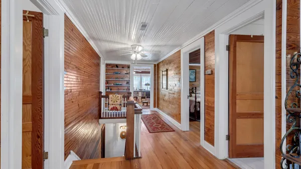 a view of a livingroom with furniture and hardwood floor