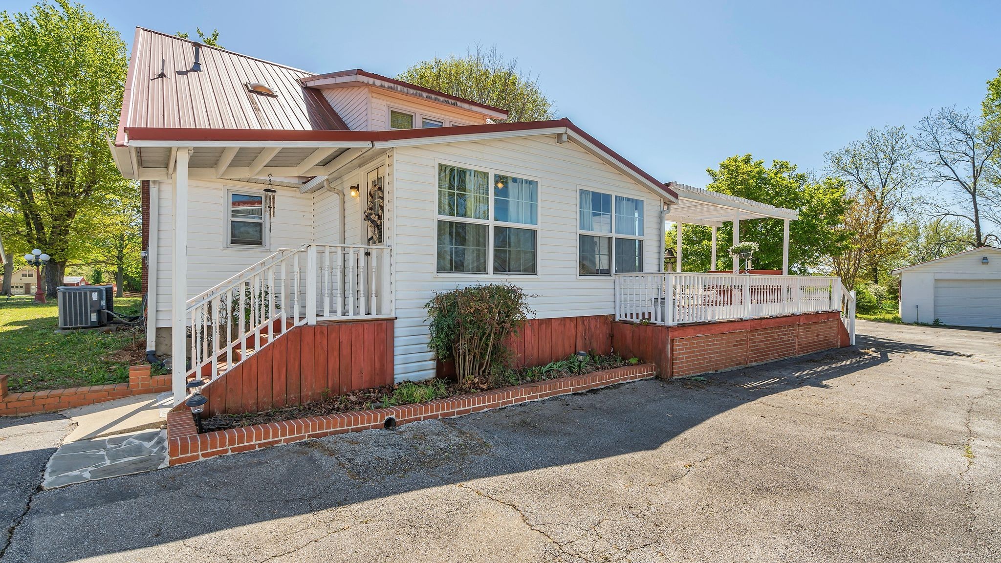 63 Old Huntsville Road Fayetteville, TN 37334 - Photo 6 of 36 a front view of a house with a yard and outdoor seating