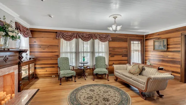 a living room with furniture a rug and a window