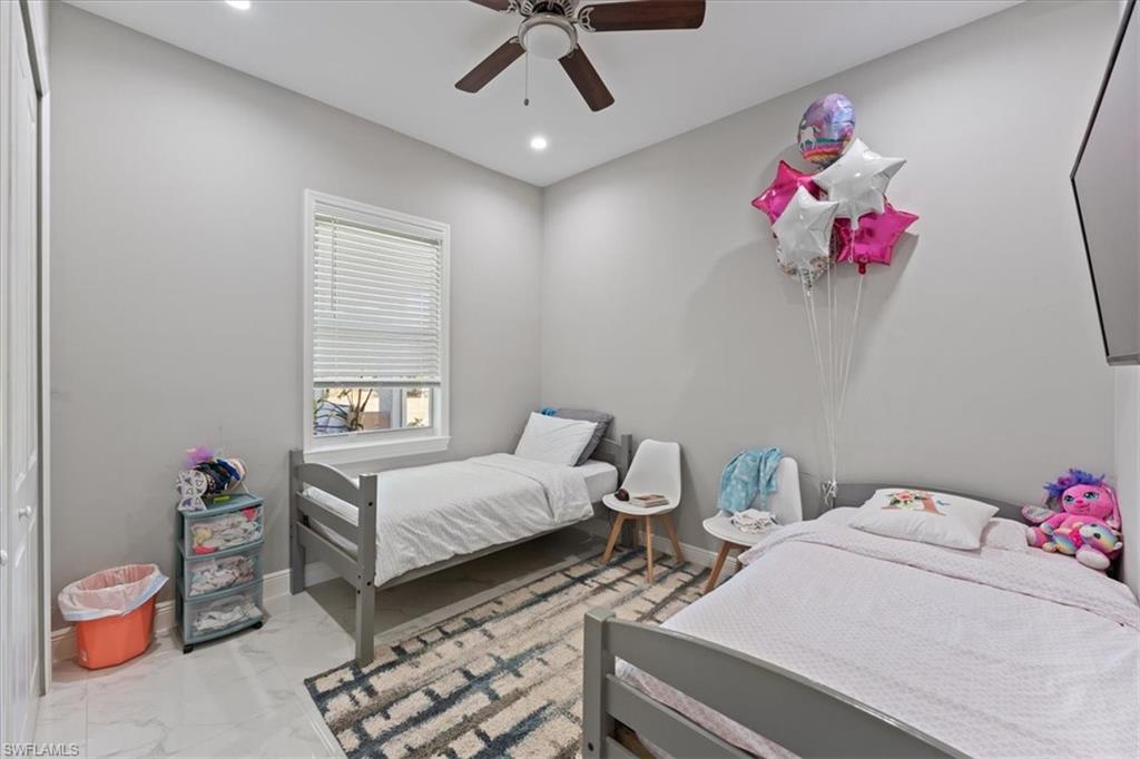 3219 64th Avenue Northeast Naples, FL 34120 - Photo 11 of 33 Bedroom with recessed lighting, marble finish floor, baseboards, and ceiling fan