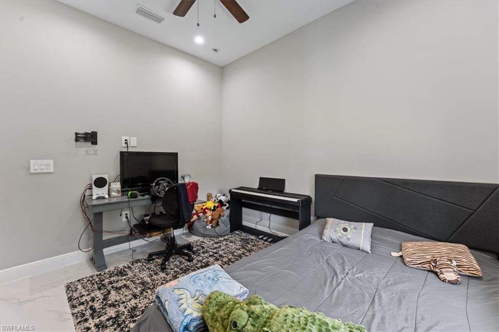 3219 64th Avenue Northeast Naples, FL 34120 - Photo 14 of 33 Bedroom featuring a ceiling fan, baseboards, visible vents, recessed lighting, and marble finish floor