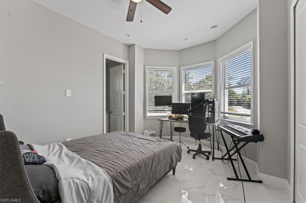 3219 64th Avenue Northeast Naples, FL 34120 - Photo 15 of 33 Bedroom with a ceiling fan, baseboards, and marble finish floor