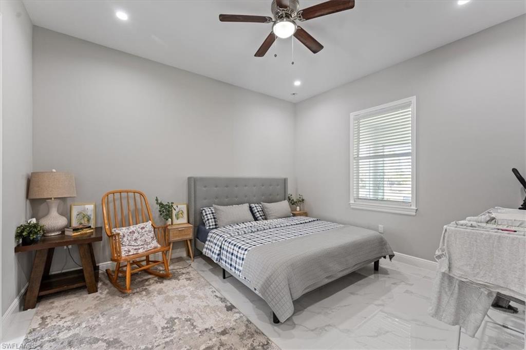 3219 64th Avenue Northeast Naples, FL 34120 - Photo 17 of 33 Bedroom featuring recessed lighting, baseboards, marble finish floor, and ceiling fan