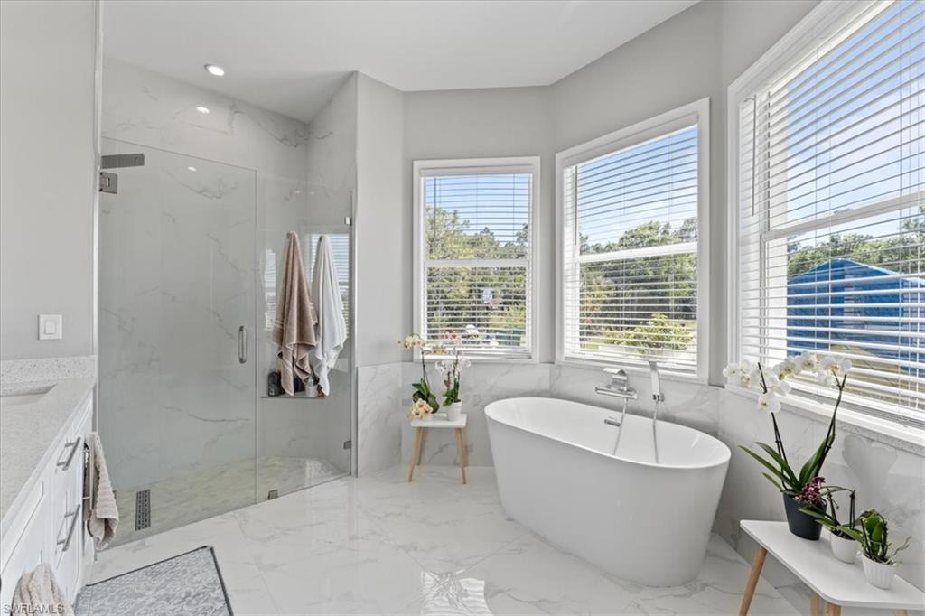 3219 64th Avenue Northeast Naples, FL 34120 - Photo 19 of 33 Full bathroom featuring vanity, a marble finish shower, a soaking tub, recessed lighting, and marble finish floor
