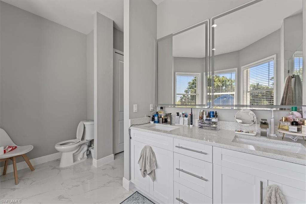 3219 64th Avenue Northeast Naples, FL 34120 - Photo 20 of 33 Full bath featuring a sink, baseboards, toilet, and marble finish floor