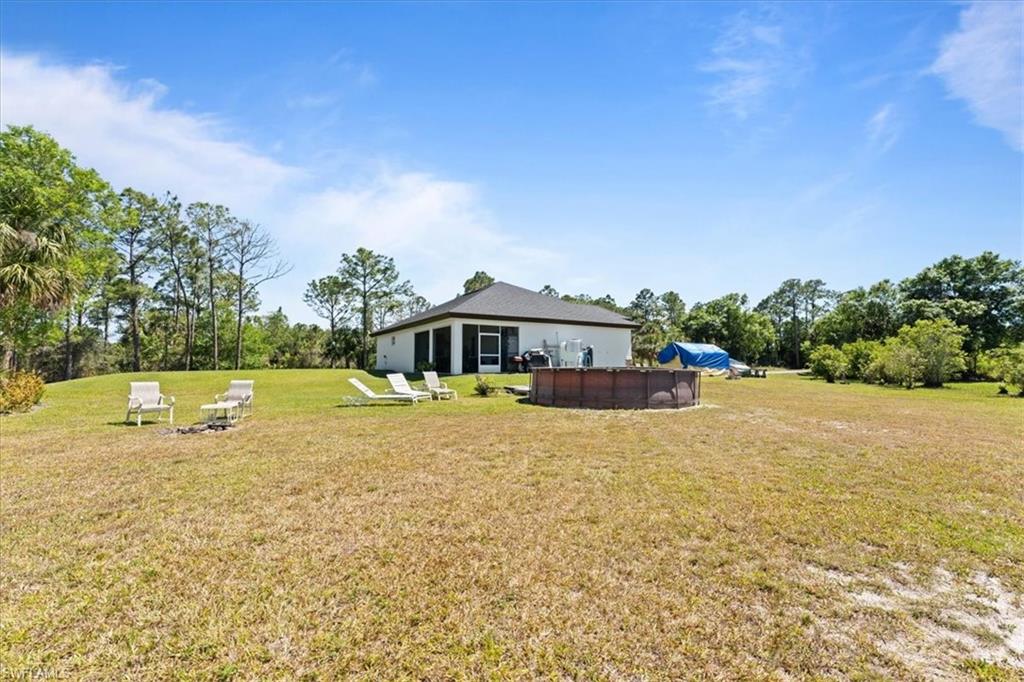 3219 64th Avenue Northeast Naples, FL 34120 - Photo 24 of 33 View of yard with an outdoor pool