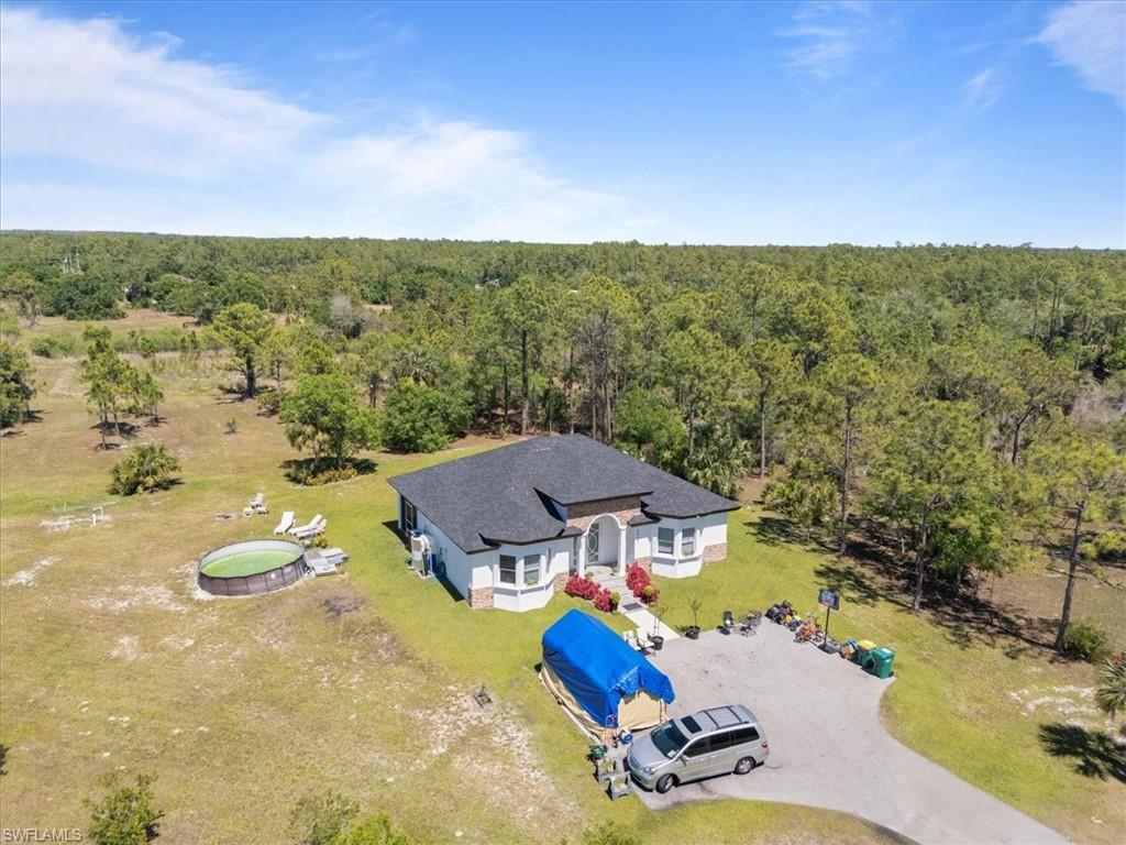 3219 64th Avenue Northeast Naples, FL 34120 - Photo 28 of 33 Aerial view featuring a view of trees
