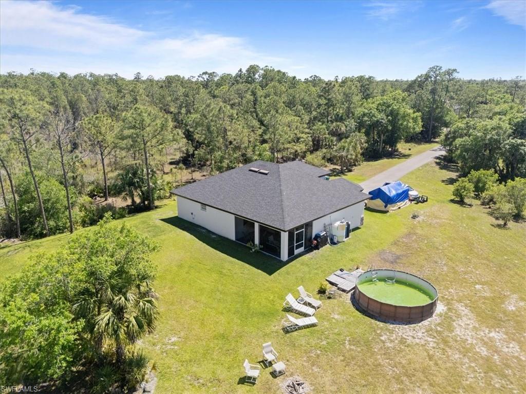 3219 64th Avenue Northeast Naples, FL 34120 - Photo 29 of 33 Bird's eye view featuring a wooded view