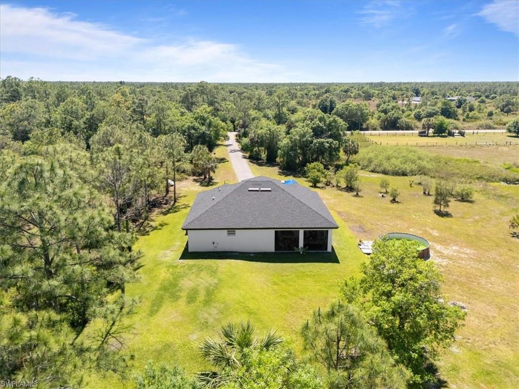 3219 64th Avenue Northeast Naples, FL 34120 - Photo 30 of 33 Birds eye view of property featuring a view of trees