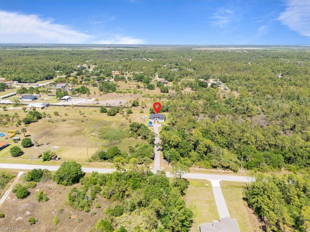 3219 64th Avenue Northeast Naples, FL 34120 - Photo 31 of 33 Birds eye view of property with a wooded view