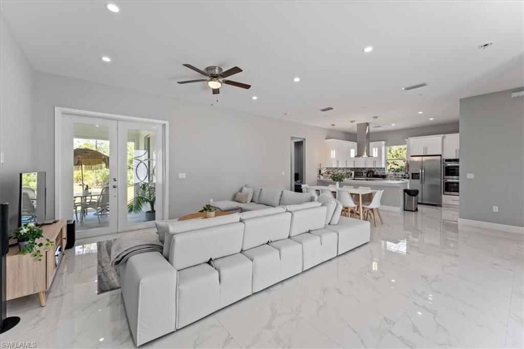 3219 64th Avenue Northeast Naples, FL 34120 - Photo 4 of 33 Living room with a ceiling fan, recessed lighting, french doors, and a wealth of natural light