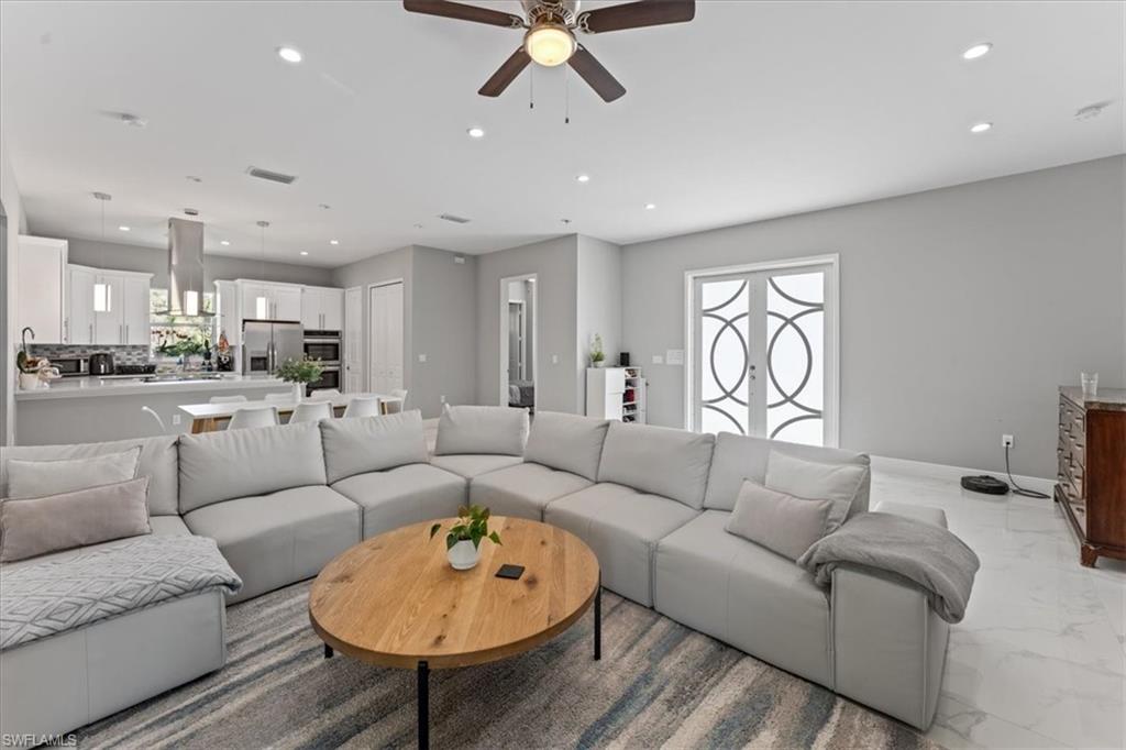 3219 64th Avenue Northeast Naples, FL 34120 - Photo 6 of 33 Living area with recessed lighting, visible vents, marble finish floor, and a ceiling fan