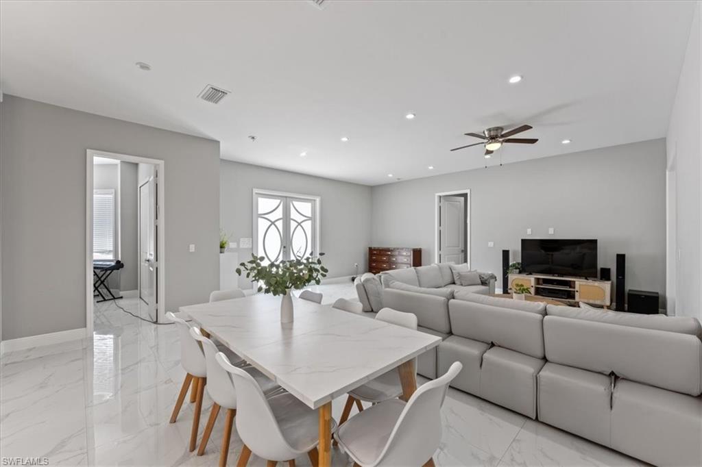 3219 64th Avenue Northeast Naples, FL 34120 - Photo 10 of 33 Dining area with visible vents, marble finish floor, recessed lighting, baseboards, and ceiling fan