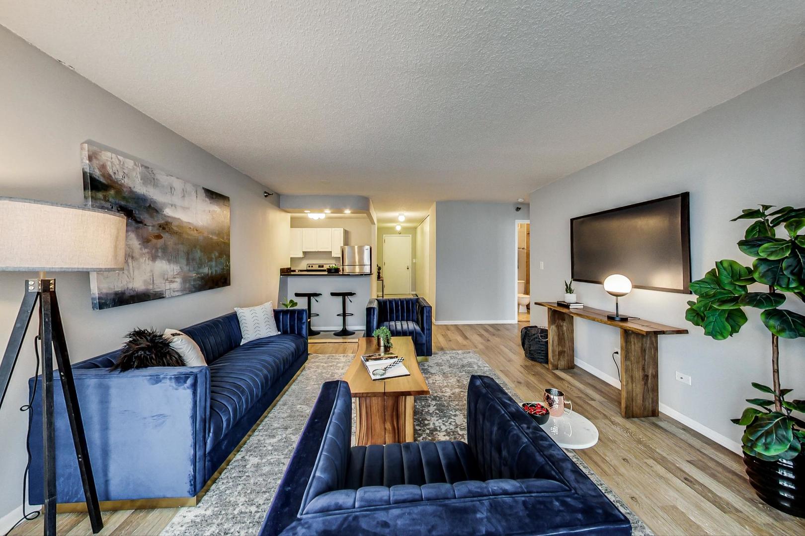 111 West Maple Street, Unit 3005 Chicago, IL 60610 - Photo 5 of 18 a living room with furniture and a flat screen tv