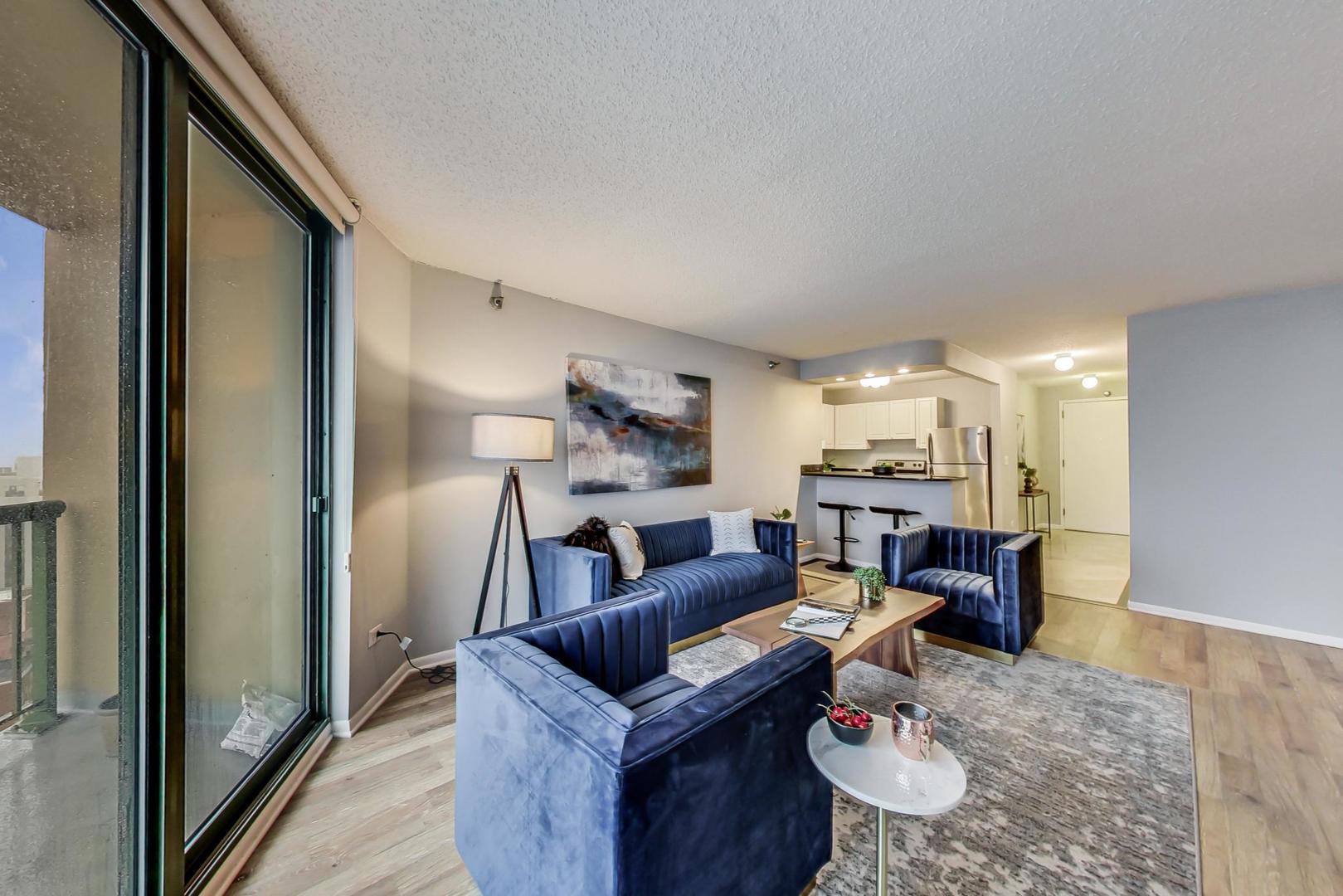 111 West Maple Street, Unit 3005 Chicago, IL 60610 - Photo 7 of 18 a living room with furniture and a fireplace