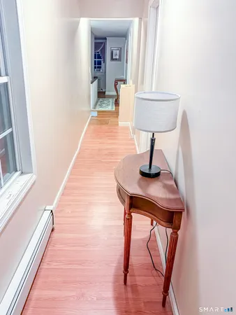 a hallway with a table and a mirror