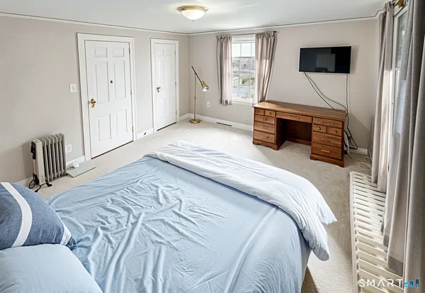 a bedroom with a bed and a television