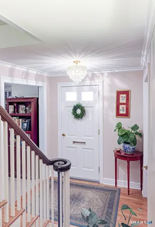 a view of a hallway to a livingroom with furniture