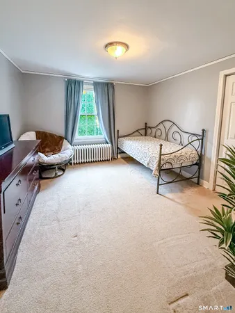 a spacious bedroom with a bed and a window