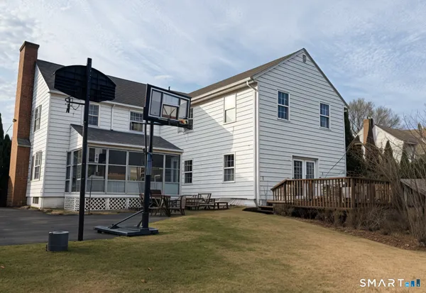 a backyard of a house with barbeque oven and table