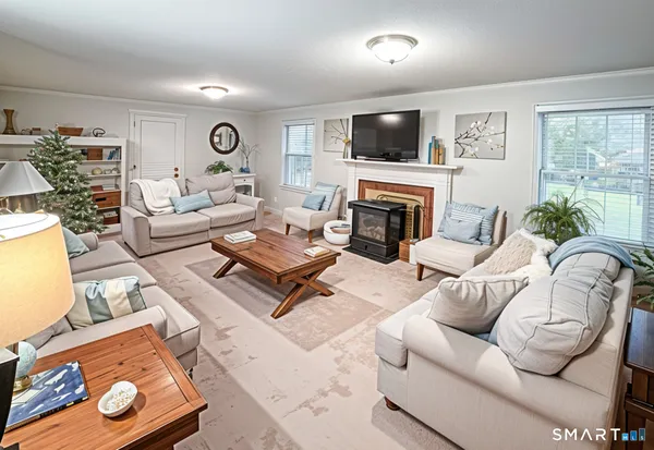 a living room with furniture a fireplace and a flat screen tv