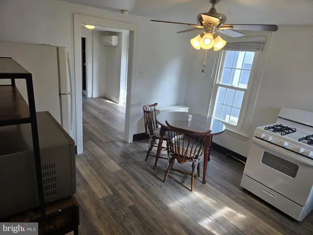 a view of a dining room with furniture and chandelier