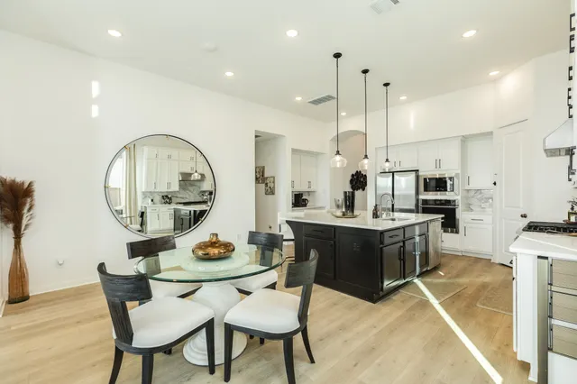 a kitchen with a table and chairs in it