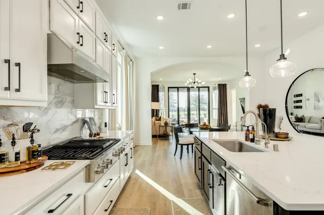 a kitchen with sink stove and cabinets