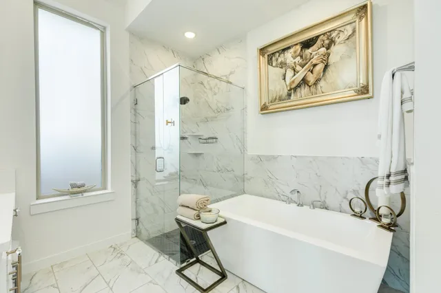 a spacious bathroom with a double vanity sink mirror and bathtub