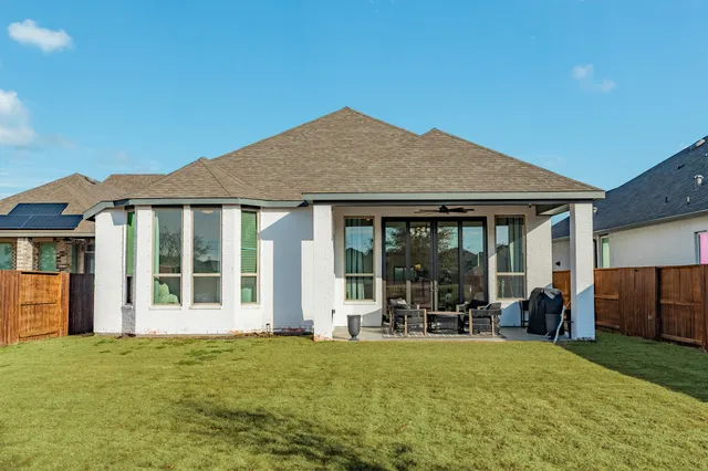a living room with furniture and large windows