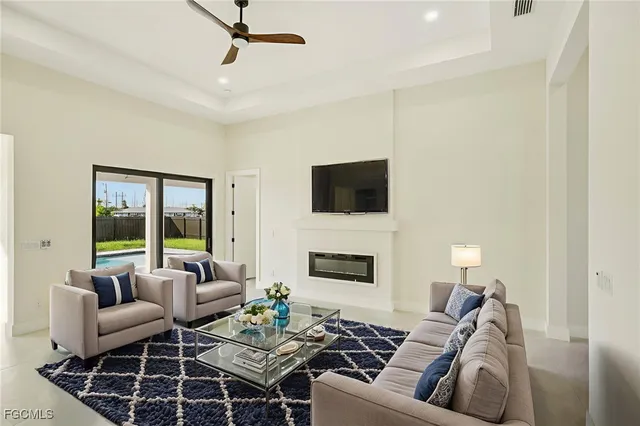 a view of an empty room with a fireplace and a window