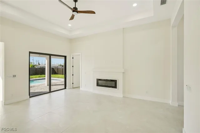 an empty room with fan and windows