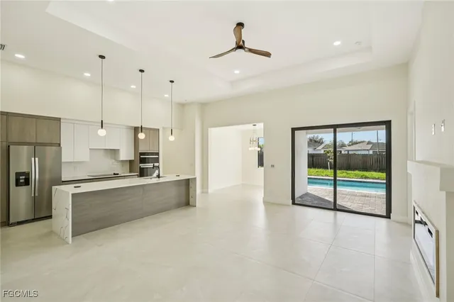 a kitchen with a sink and stainless steel appliances