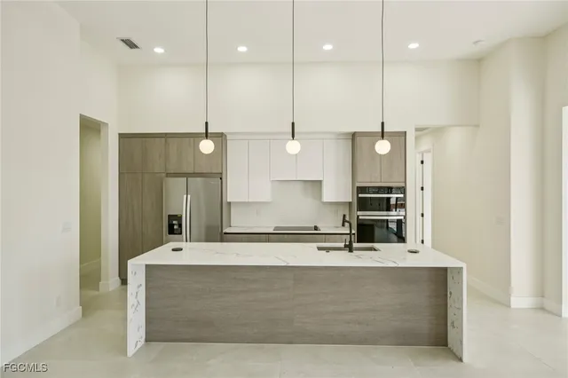 a kitchen with a sink a counter and stainless steel appliances