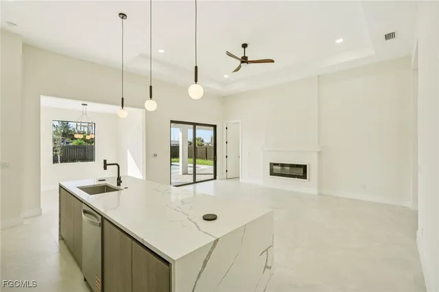 a large kitchen with white cabinets and stainless steel appliances