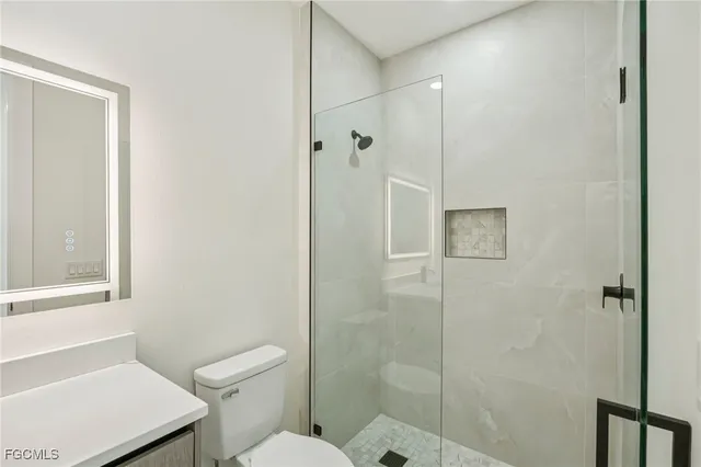 an empty room with a ceiling fan and a rug