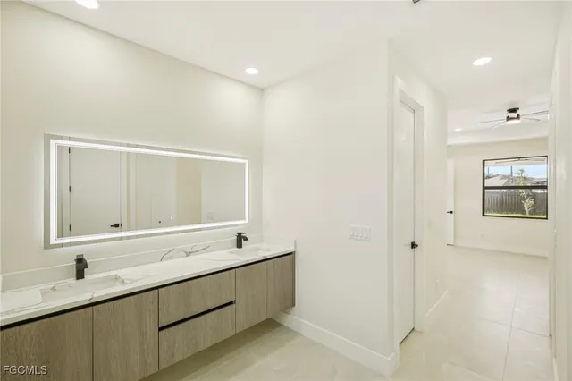 a bedroom with a sink and a mirror