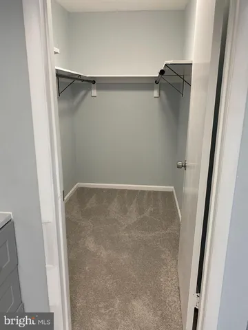 a view of a room with wooden floor and large window