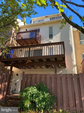 a view of a house with wooden deck