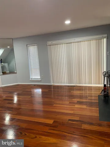 a view of a room with wooden floor and window