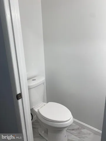 a white toilet sitting next to a sink
