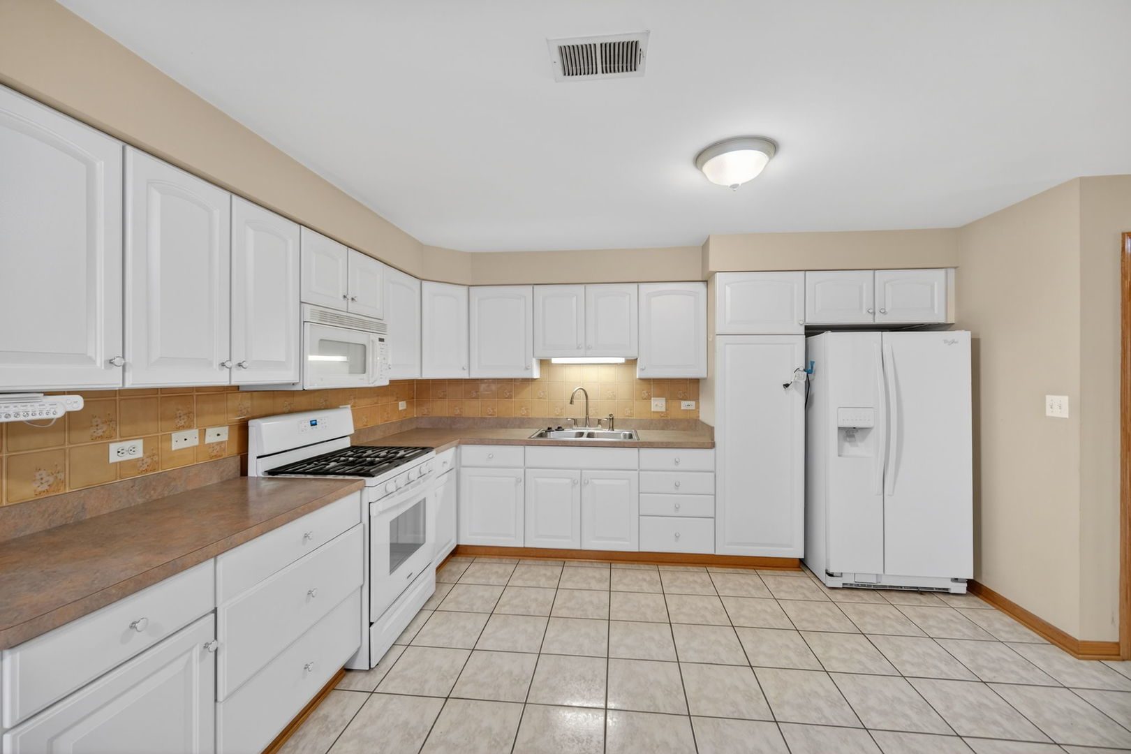 4369 North Elston Avenue Chicago, IL 60641 - Photo 26 of 43 a kitchen with granite countertop white cabinets and stainless steel appliances