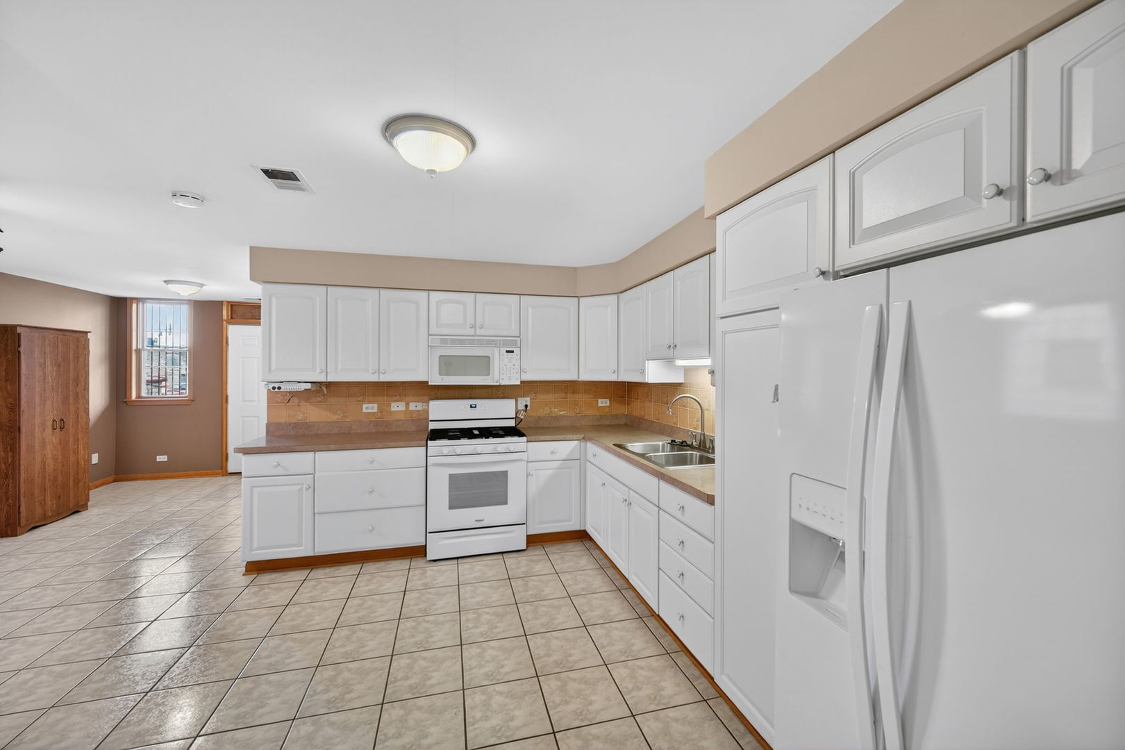 4369 North Elston Avenue Chicago, IL 60641 - Photo 33 of 43 a kitchen with granite countertop a refrigerator and a stove top oven