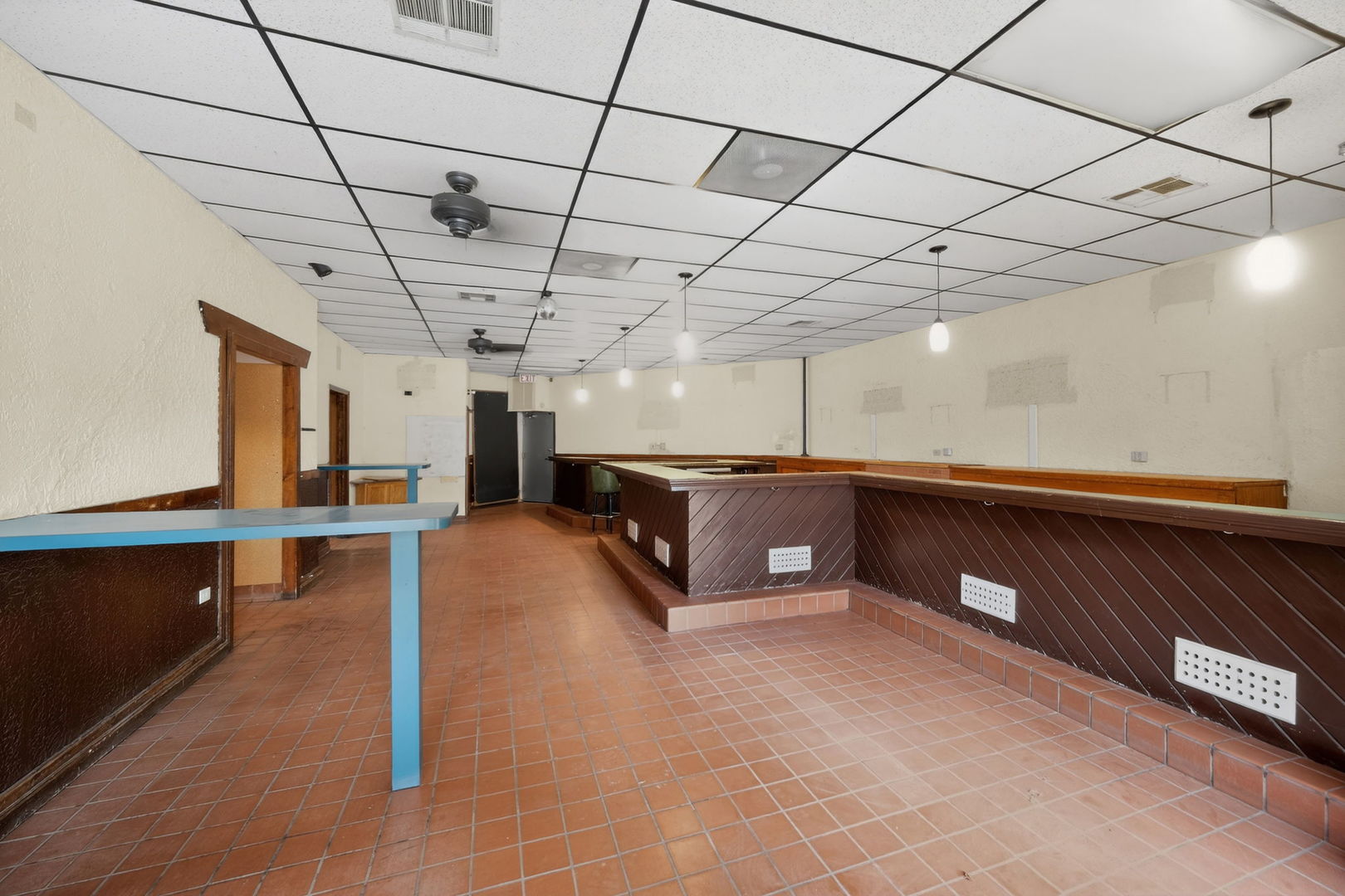 4369 North Elston Avenue Chicago, IL 60641 - Photo 5 of 43 a large room with lots of wooden furniture and a chandelier